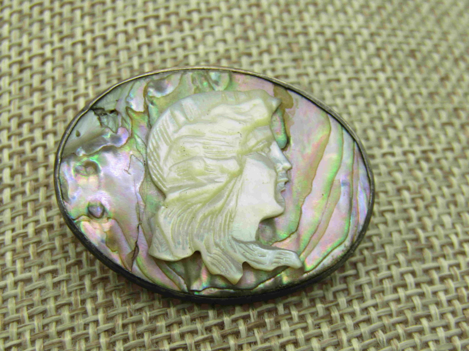 Vintage Sterling Silver Abalone Mother-o-Pearl Cameo: Vintage Sterling Silver Abalone Mother-of-Pearl Cameo Style Brooch, 1910-1920's, C-clasp, 1.5" wide and 1" tall. Abalone background, bezel-set with raised carveed mother-of-pearl cameo. Oval, weight i
