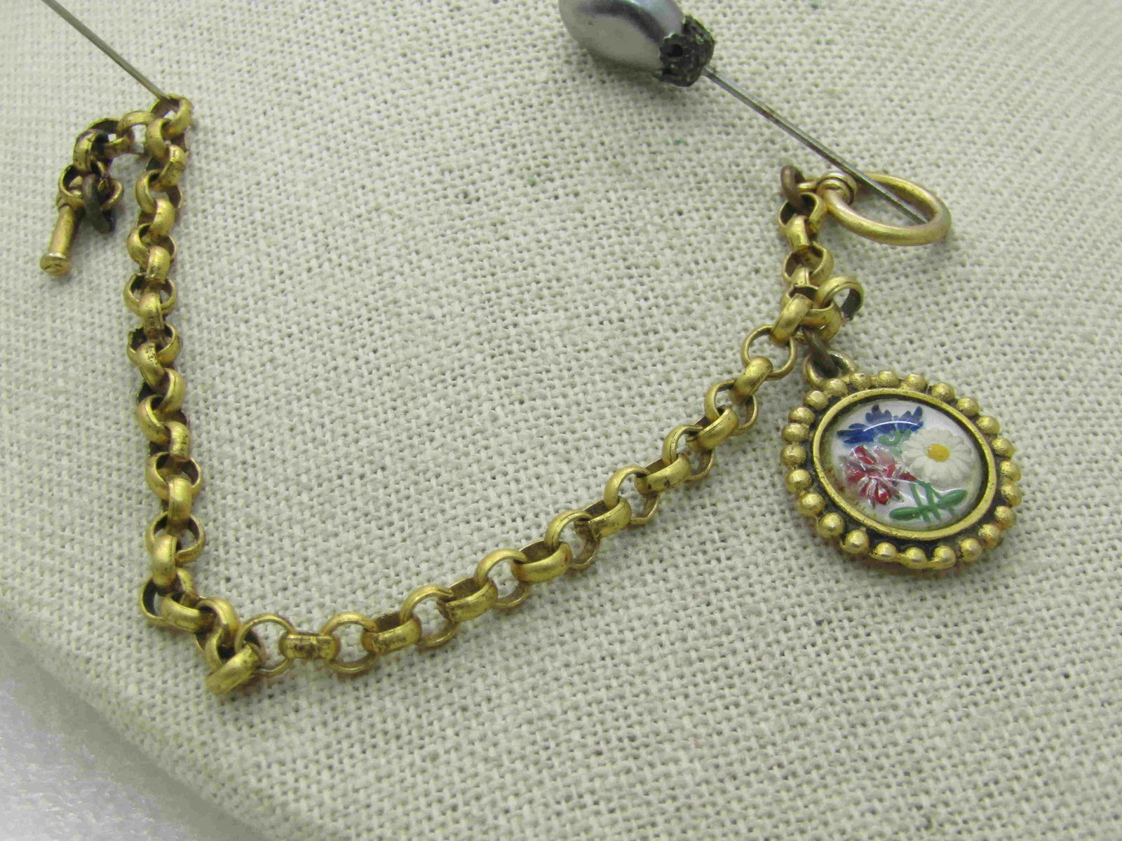 Vintage Enameled Floral Rolo Link Bracelet, Toggle: Vintage Enameled Floral Rolo Link Bracelet, Toggle Clasp, 7.5", nearly 4mm wide. Rounded dotted charm pwith a glass dome over three enameled flowers under the glass. The charm is appx. 1" wide.I belie