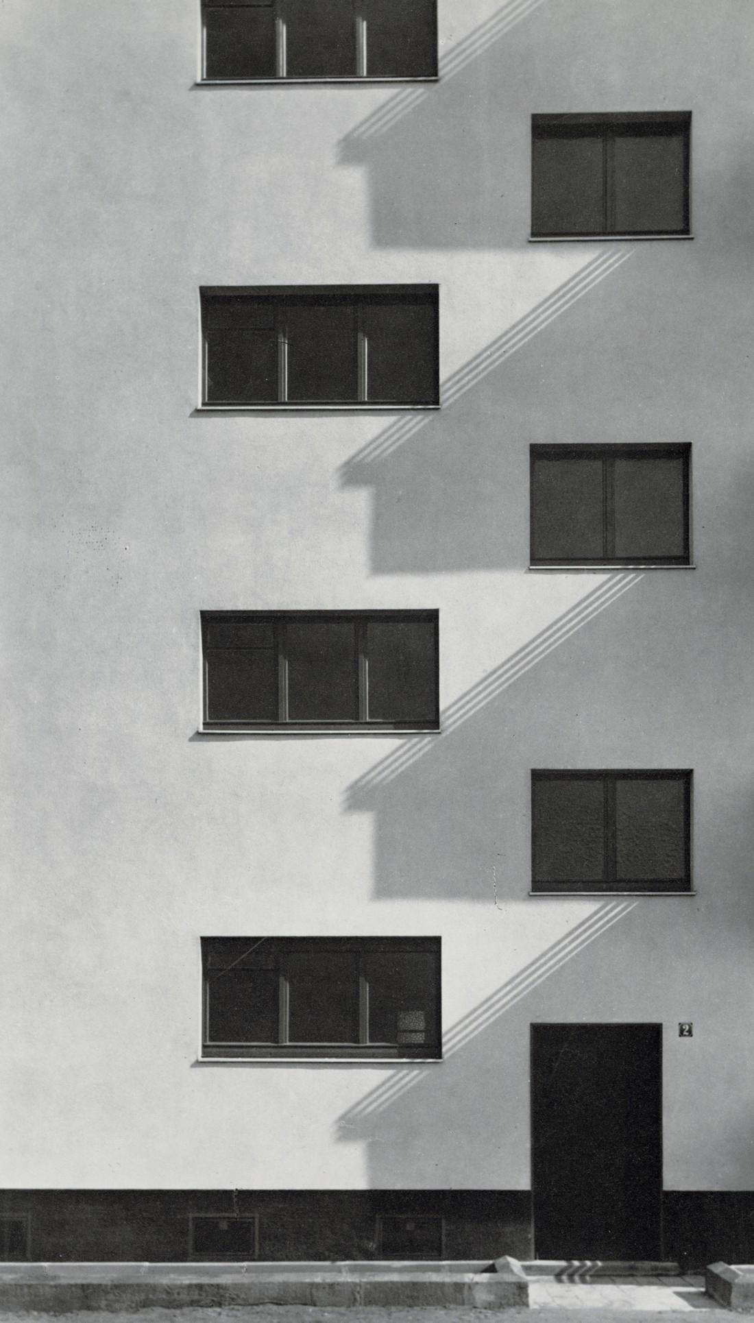 WERNER MANTZ - Residential Apartment, Cologne, 1928: Artist: WERNER MANTZ Title: Entrance Residential Apartment Block, Cologne, 1928 Medium: Photo Litho, 1989, USA Dimensions: 6x10.5" Description: Heat Wax Mounted on 11x14" Conservation Board Artist Bio