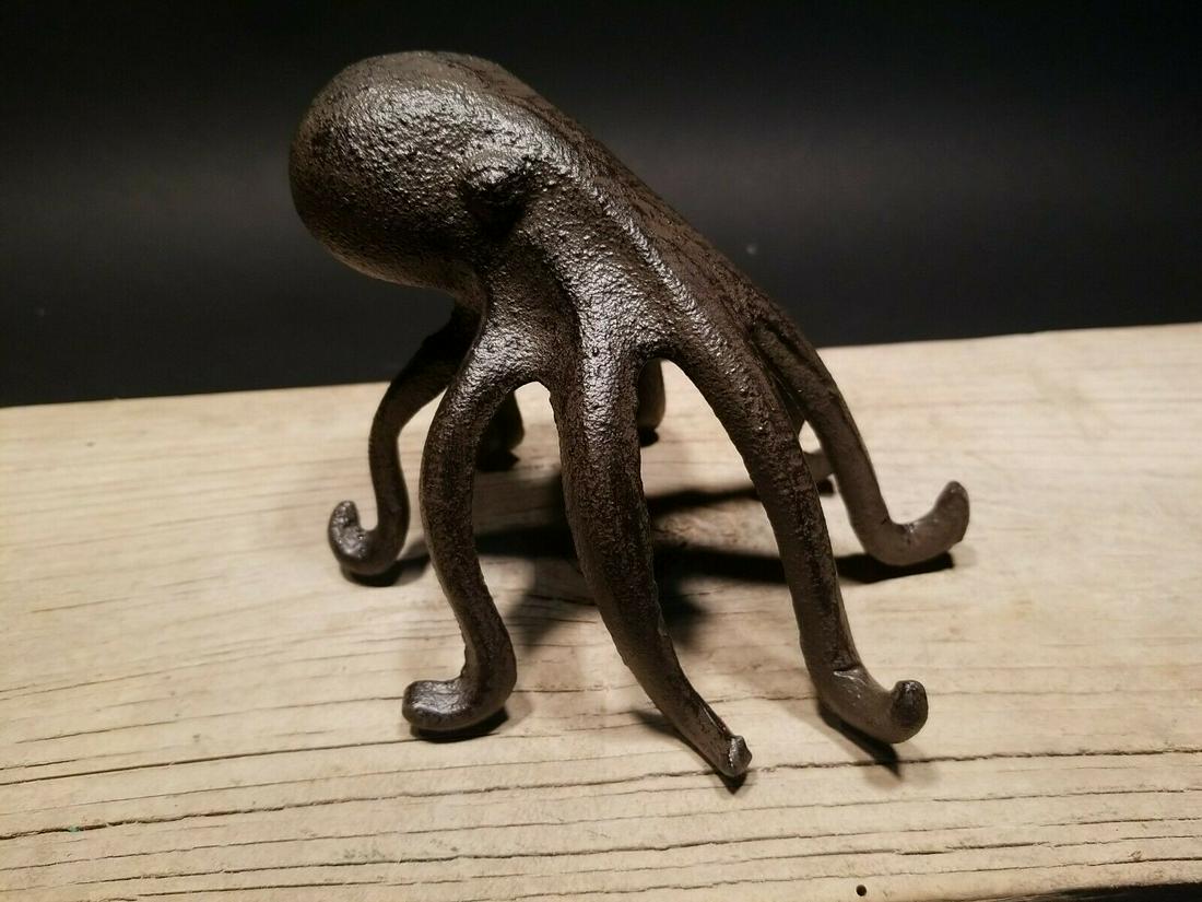 Cast Iron Octopus Phone Stand Paperweight: 4 1/2" Tall x 6" wide Nice heavy cast iron octopus phone holder stand. Works great as a decorative item or paperweight. Reserve: $16.00 Shipping: Domestic: Flat-rate of $8.00 to anywhere within the co