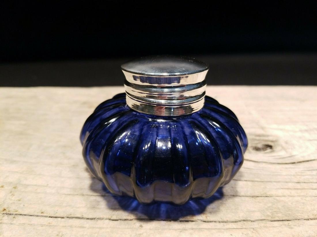 Round Blue Glass Thick Glass Inkwell Ink pot Bottle: Charming Reproduction antique blue glass inkwell ink bottle. Very heavy thick glass each with charming subtle signs of being handmade. The hinged shiny lid is nickel plated brass, possibly silver plat