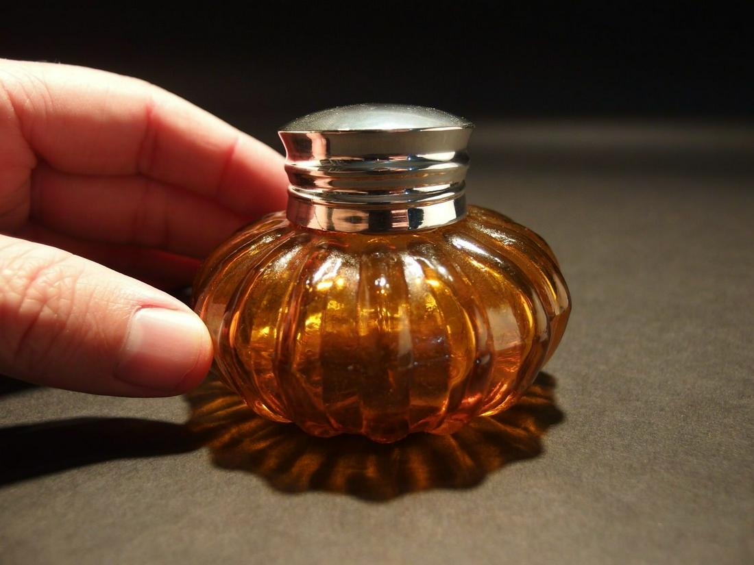 Round Amber Glass Inkwell Ink pot Bottle: Charming 2 1/4" High x 3 1/4" wide Charming Reproduction antique amber glass inkwell. Very heavy thick glass each with charming subtle signs of being hand made. The hinged shiny lid is silver plated b