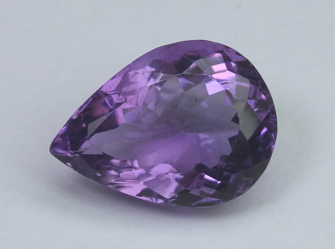 8.41 Ct Natural Amethyst: No Reserve! Title: 8.41 Ct Natural Amethyst Additional Information: Gemstone : Natural Amethyst Origin: Brazil Weight: 8.41 CaratsDimensions: 16.2x11.9x8.1 mmShape/Cut: PearColour: Purple Transparency