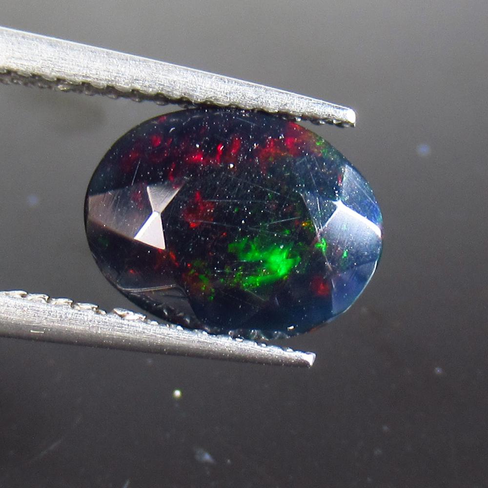 1.44 Ct Natural Ethiopian Black Fire Opal Oval Cut: No Reserve! Title: 1.44 Ct Natural Ethiopian Black Fire Opal Oval Cut Stone Clarity: Translucent Gemstone: Natural Black Opal Carat Weight: 1.44 Size/Dimensions: 10.50 x 8.00 x 4.60 mm Additional Info