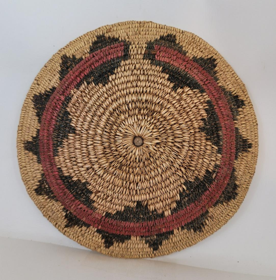 Navajo ceremonial basket ca 1940's: Title: Navajo ceremonial basket ca 1940's Dimension: 11" diameter x 2" high Provenance: Excellent condition with traces of corn meal under the stitching. Definitely a Native used basket. A wooden plug