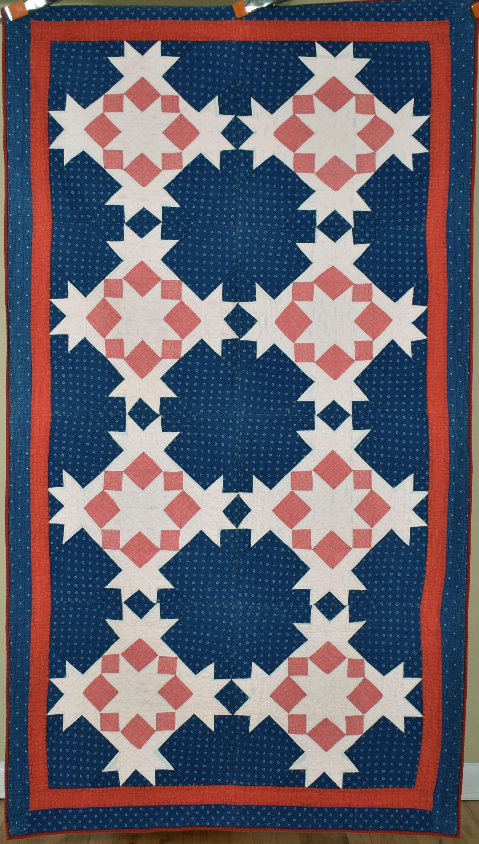 1880's Red, White & Blue Stars Quilt: Cotton 1870's/1880's red, white and blue stars/carpenter's wheel quilt is hand pieced and hand quilted, with a deep blue background. It measures 44" X 78" (trundle bed, or perhaps sized to drape over 
