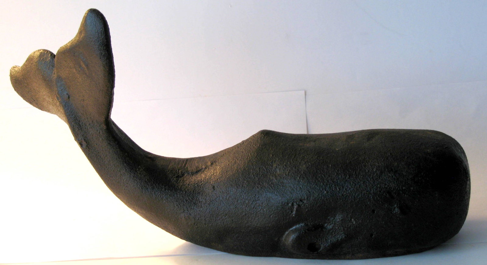 Cast iron whale doorstop.: Title: Cast iron whale doorstop. Description: Nice old cast iron whale doorstop in old original paint and good patina. Dimension: 12” x 7” Circa: 1930's Shipping: Domestic: Flat-rate of $25.00 to 