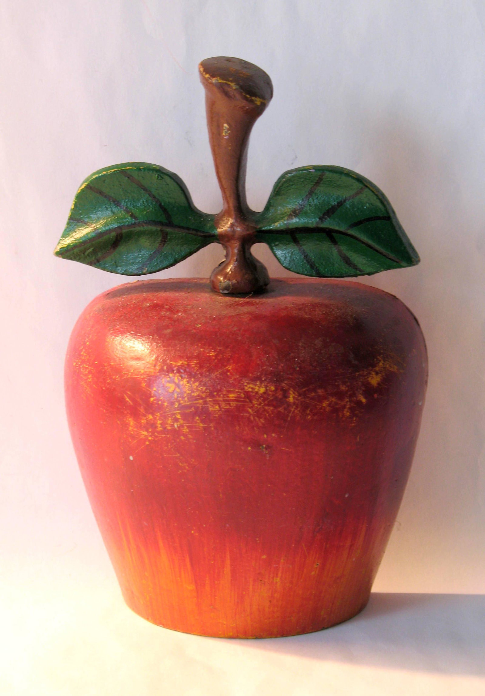 Vintage cast iron apple doorstop.: Title: Vintage cast iron apple doorstop. Description: Interesting cast iron apple doorstop in original paint & condition. Dimension: 7” x 4 1/2” Circa: 1950's Shipping: Domestic: Flat-rate o