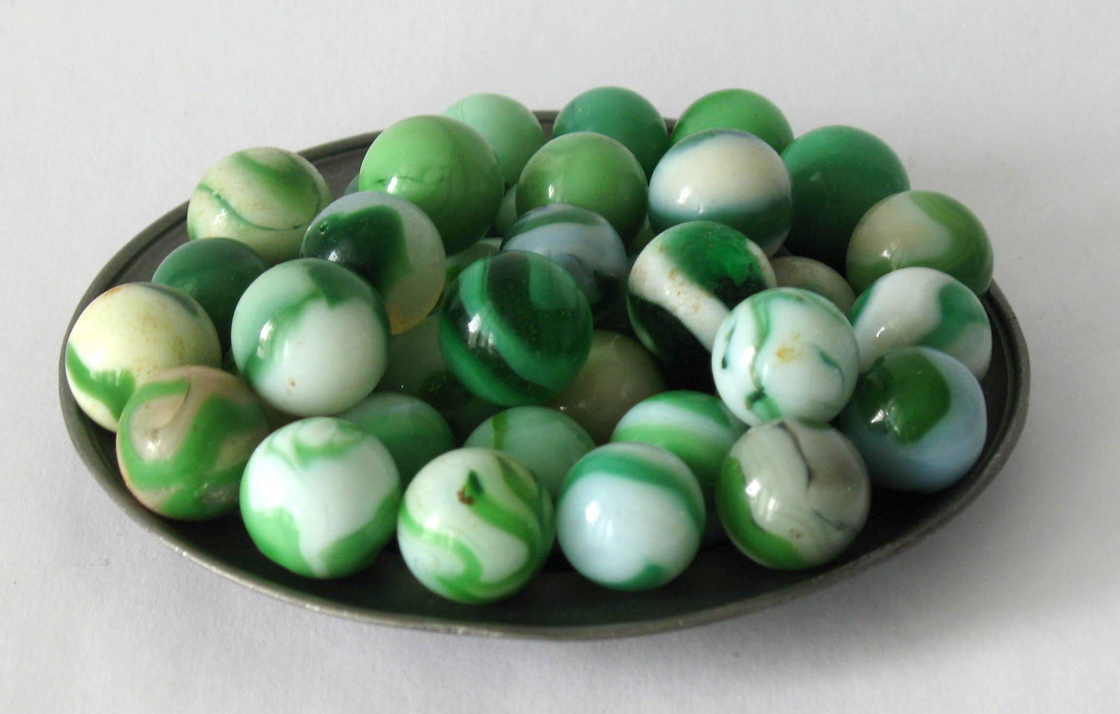 Group of early glass marbles.: Title: Group of early glass marbles. Description: Nice group of early green & white glass marbles. Dimension: normal size Circa: 1950's Shipping: Domestic: Flat-rate of $15.00 to anywhere within the c