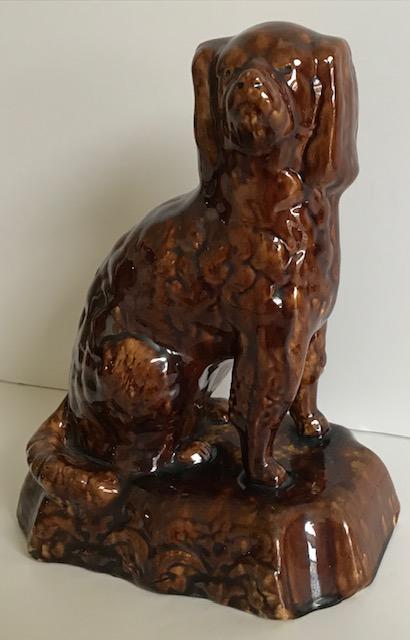 Yelloware Spaniel with Rockingham glaze: Title: Yelloware Spaniel with Rockingham glaze Dimension: Measures 10” tall by 8” wide at base. Provenance/Additional Info: Good figure of a seated dog in excellent condition, no chips or cr