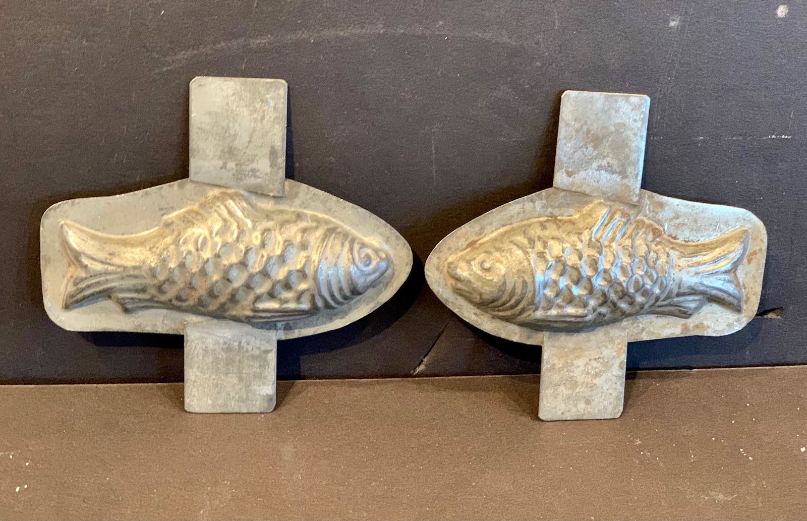 Pair of handled Fish Chocolate Mold, early 20th c: Title: Pair of handled Fish Chocolate Mold, early 20th c Description: Superbly detailed, wonderful patina, remarkable diminutive scale. Dimension: 4 1/2” x 4 1/2” Circa: Early 20th c Shipping: Dom