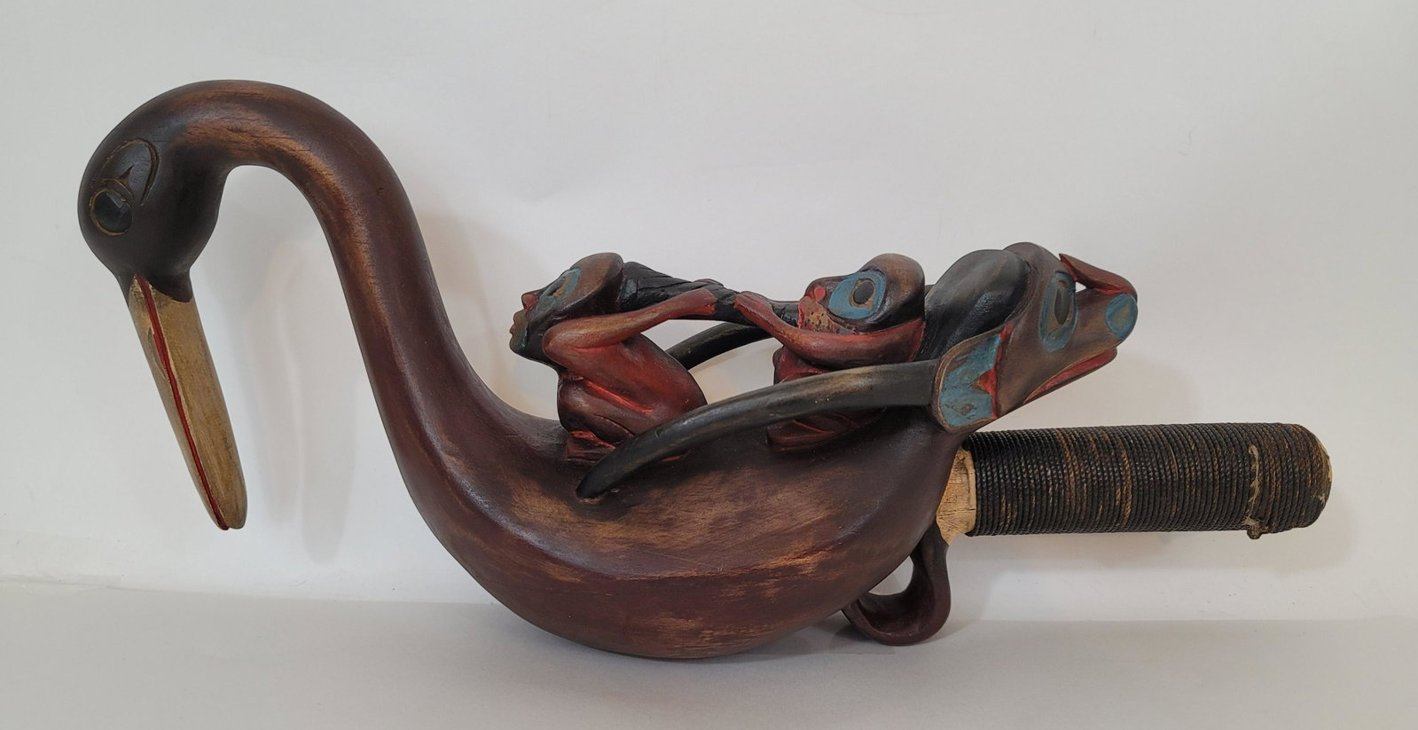 Carved and painted Shaman's rattle. Mid 20th century: Title: Carved and painted Shaman's rattle. Mid 20th century Dimension: 17" long x 7" high x 4 1/2" wide Provenance: A Tlingit image of a witch being tortured by a Shaman is an iconic image in the Tlin