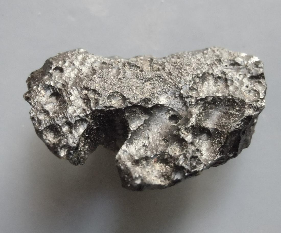 PHILIPPINITE TEKTITE - FROM METEORITE IMPACT: Title: PHILIPPINITE TEKTITE - FROM METEORITE IMPACT Origin: Paracale, Camarines Norte, Luzon, Philippines Size: 2.5x1.5x0.5 cm / 4 gram Description: flat, deeply notched rizalite/philippinite tektite.