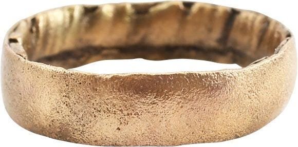RARE ANCIENT VIKING WEDDING RING, SIZE 6: C.850-1050 AD. Rounded band size 6, 4.6mm. Made with a central core to distribute the molten metal and heat. The core was then laboriously removed by hand with the remnants visible. Surface lightly te