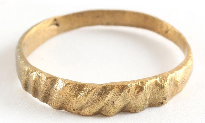 ANCIENT VIKING TWISTED FORM RING, SIZE 7: 8th-10th century AD. Tapered from the bottom (1.7mm) to the top (3.4mm). A wedding ring or pinky ring, size 7. The surface with a deep hand-cut spiral motif at the top, about a third of its circumfere