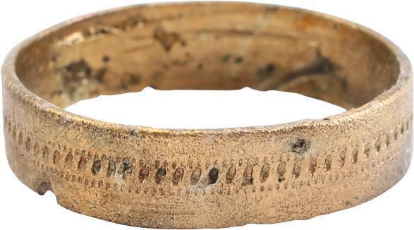 FINE ANCIENT VIKING WEDDING RING, SIZE 5: 4.8mm width with a flat face with a hand stippled band in the center. Made with a central core to distribute the molten metal and heat. The core was then laboriously removed by hand with the remnants 