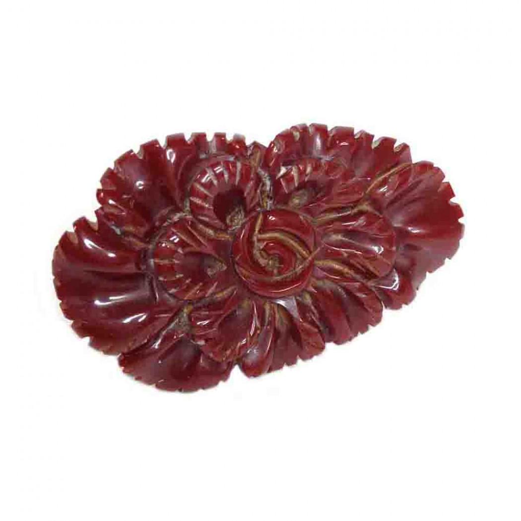 Red Bakelite Floral Dress Clip: Overview Vintage costume jewelry from the 1930-40s Materials: Bakelite, Brass A carved red bakelite floral dress clip with metal clasp. Can also be worn as the brooch or just clip on a clutch. Dimensi