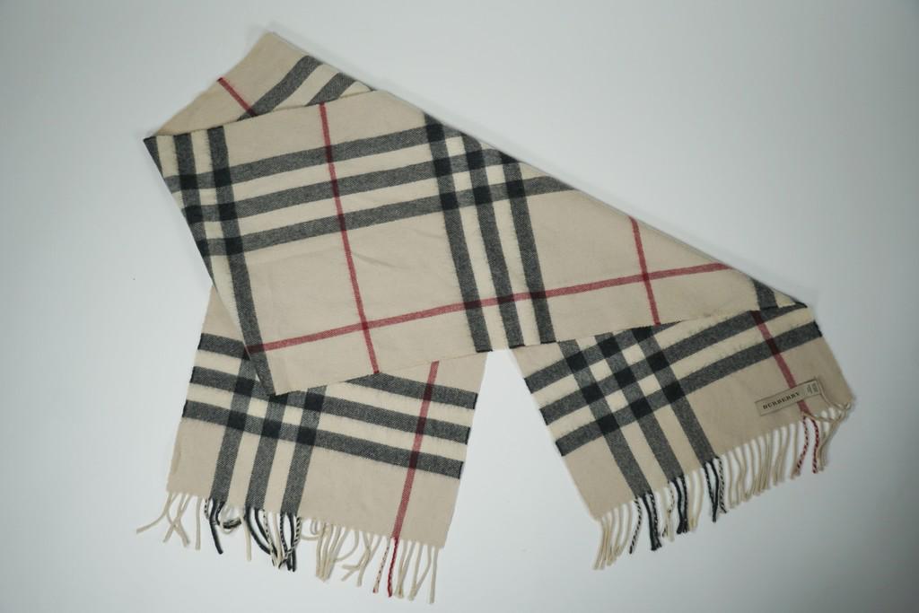 Burberry Scarf: Title: Burberry Scarf Brand: Burberry Date/Period: N/A Materials: cashmere Measurement: L 64" W 13" Additional Information: Wear. Small holes/ wearing, a little bleeding of the colors Reserve: $45.00