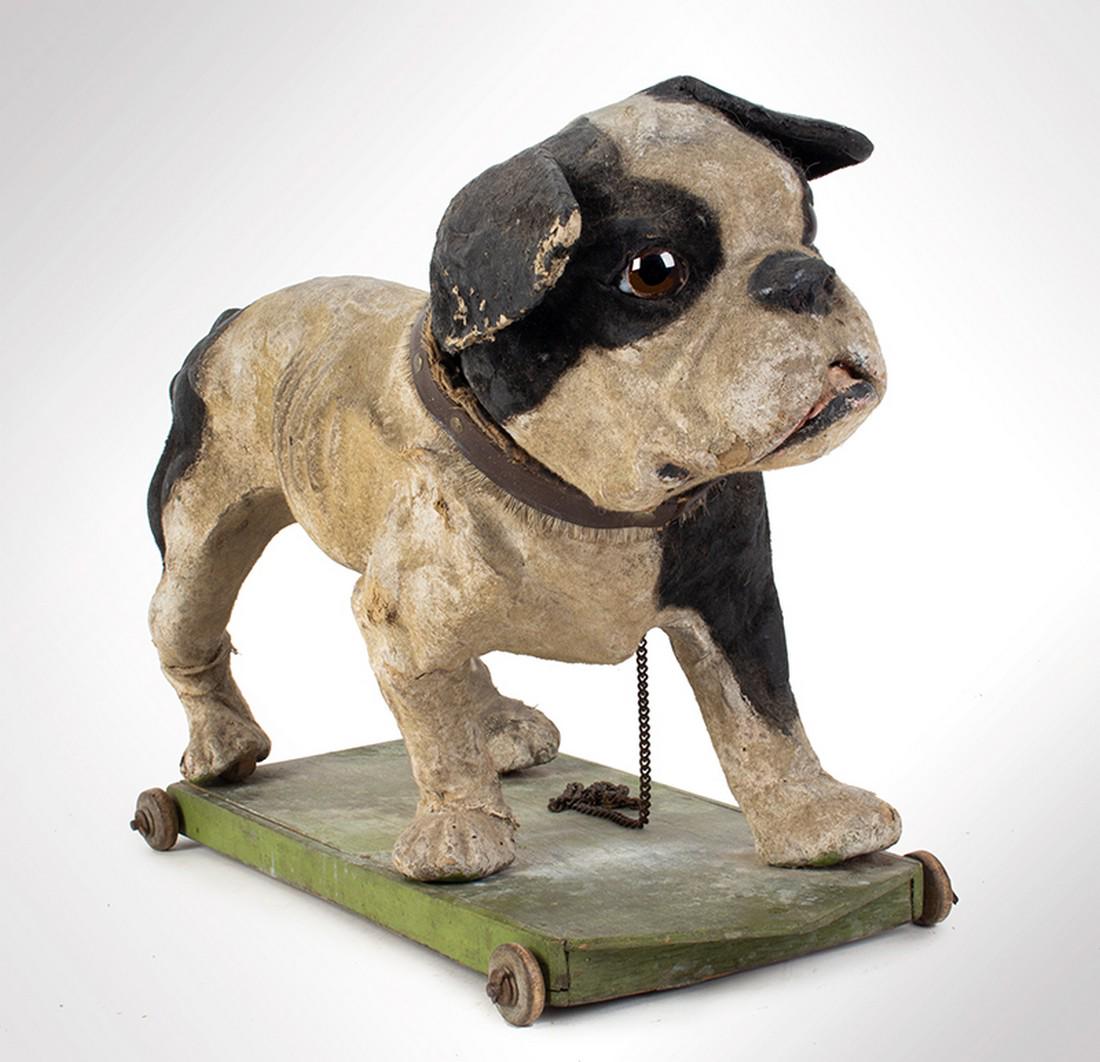 Paper Mache Bulldog Pull Toy, German: SKU: 1064-16 Title: Paper Mache Bulldog Pull Toy, German Date/Period: c 1900 Measurement: 18" x 13" Material: Flocked Paper Mache, Glass Eyes Condition: Some roughness at the paws but overall good con