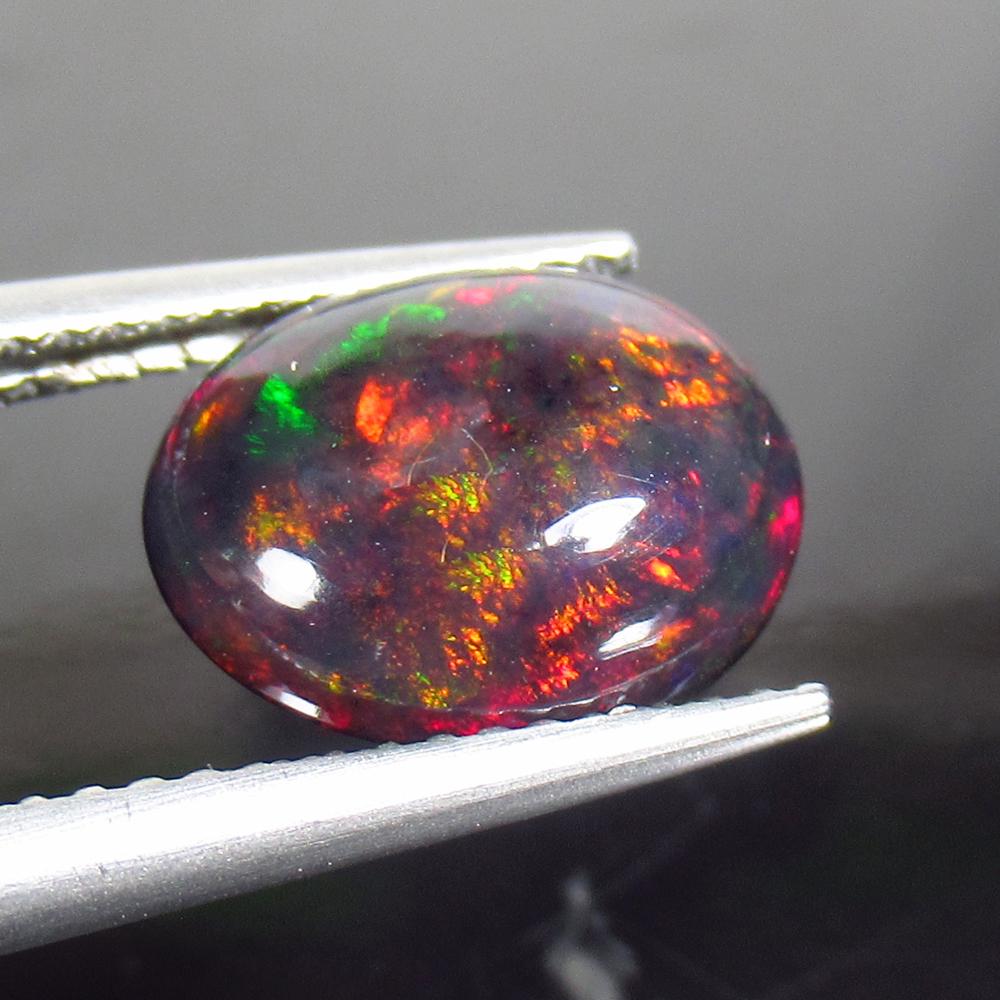 2.07 Ctw Natural Ethiopian Black Fire Opal Oval Cab: Title: 2.07 Ctw Natural Ethiopian Black Fire Opal Oval Cab Stone Clarity: Translucent Gemstones: Black Opal Size/Dimensions: 2.07 Carat Weights: 11.30 x 9.10 x 4.30 mm Additional Information: Excellen