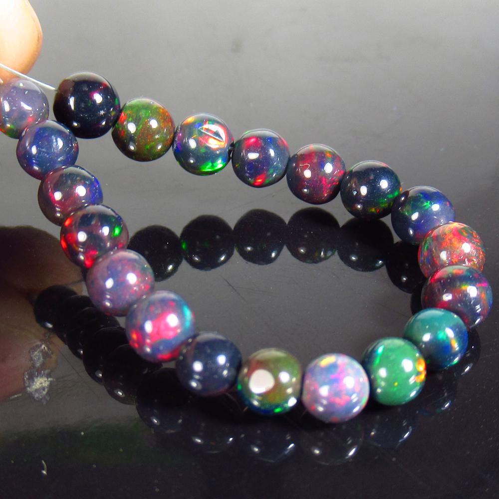 10.32 Ctw Natural 20 Drilled Black Opal Ball Beads: Title: 10.32 Ctw Natural 20 Drilled Black Opal Ball Beads Stone Clarity: Translucent Gemstones: Black Opal Beads Size/Dimensions: 10.32 Carat Weights: 4.50 to 5.50 mm / 20 PC's Additional Information: