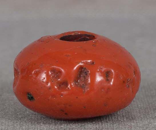 19c glass OJIME netsuke slide red coral: 19th century glass ojime (slide bead for tightening the cord going from netsuke to inro) in flattened ball shape rather well imitating red coral including natural caverns in it. Beautiful texture to t