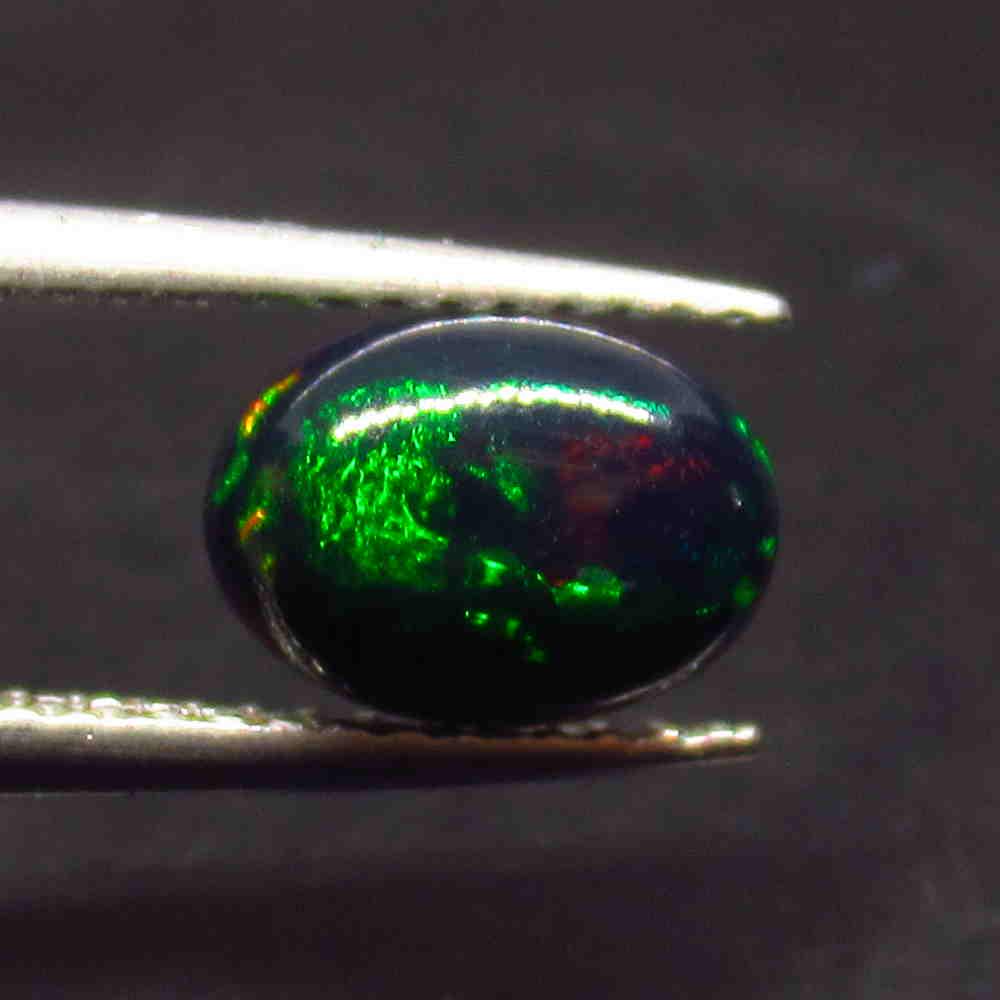 0.88 Ctw Natural Ethiopian Black Fire Opal Oval Cab: No Reserve! Title: 0.88 Ctw Natural Ethiopian Black Fire Opal Oval Cab Stone Clarity: Translucent Gemstone:Black Opal Carat Weight: 0.88 Size/Dimensions: 8.30 x 6.10 x 3.50 mm Additional Information: 