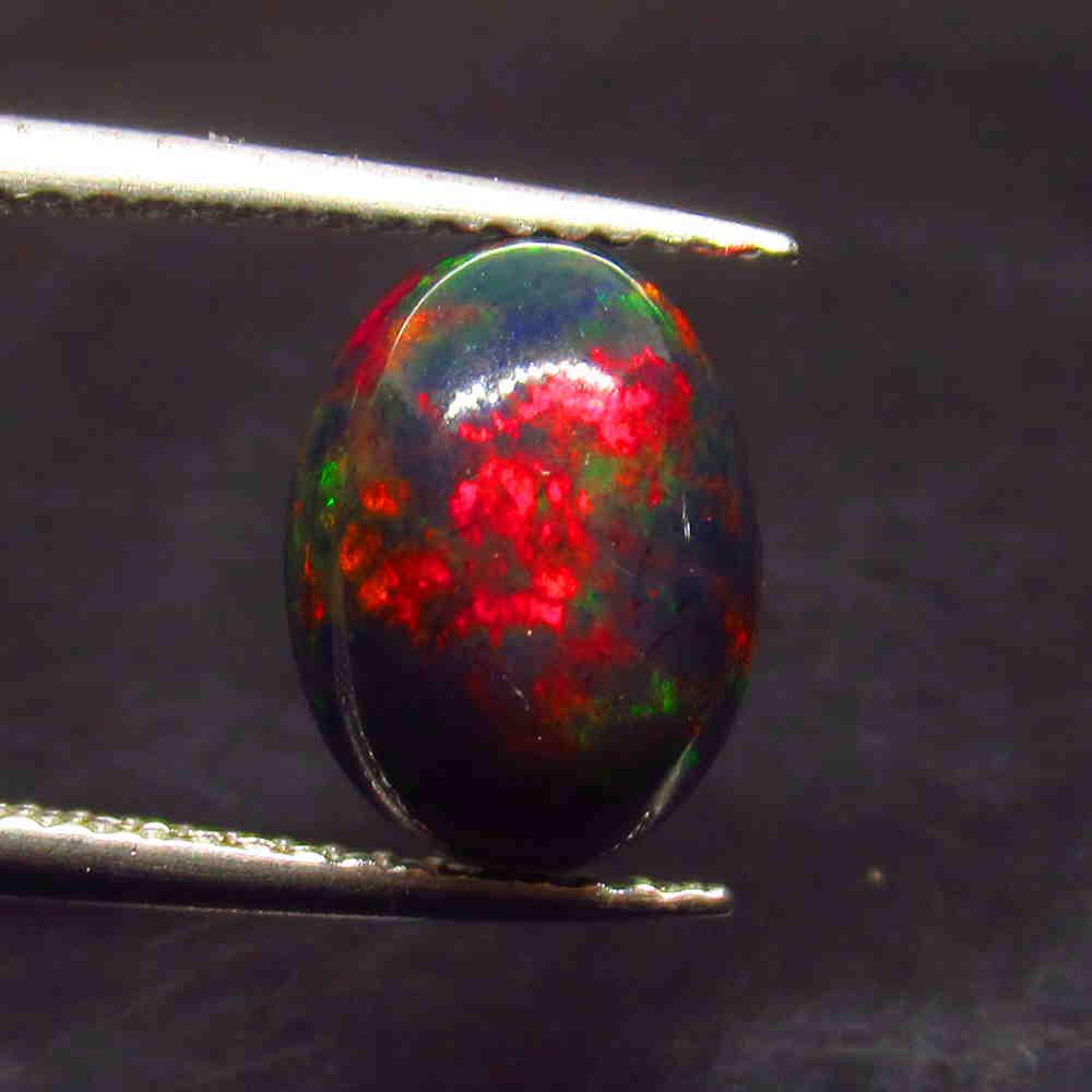 2.08 Ctw Natural Ethiopian Black Fire Opal Oval Cab: No Reserve! Title: 2.08 Ctw Natural Ethiopian Black Fire Opal Oval Cab Stone Clarity: Translucent Gemstone:Black Opal Carat Weight: 2.08 Size/Dimensions: 10.60 x 8.10 x 5.00 mm Additional Information: