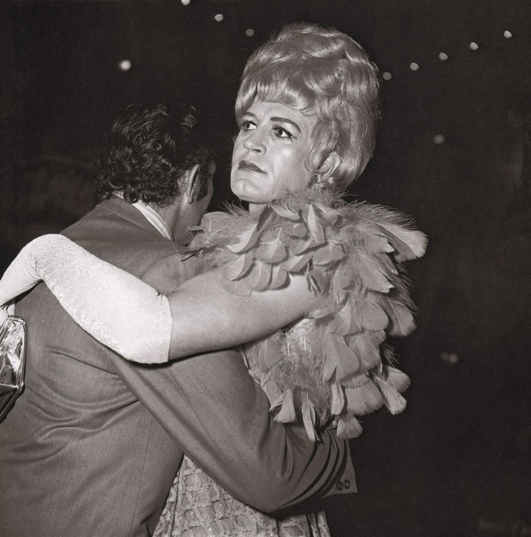 DIANE ARBUS - Two men dancing at a drag ball, NYC 1970: Artist: DIANE ARBUS Print Title: Two men dancing at a drag ball, NYC 1970 Medium: Photoengraving Printed 1970’s in the US Image size (inches) approx. 8 x 8” Diane Arbus (1923 –1971),was an Ameri