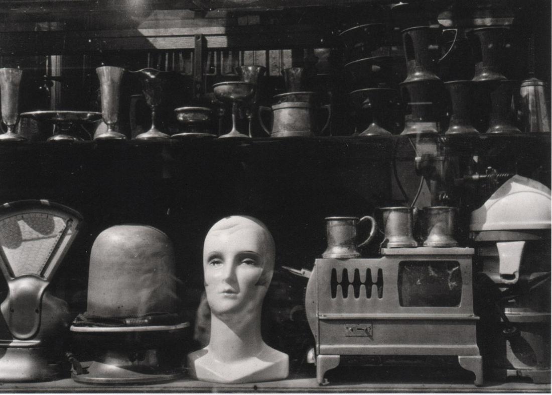WALKER EVANS - Secondhand Shop Window, 1930: Artist: WALKER EVANS Print Title: Secondhand Shop Window, 1930 Printing Date: 2000’s Medium: Photolithograph Printed in: Germany Image Size: 4 x 5.5” Walker Evans(1903–1975) was one of the most