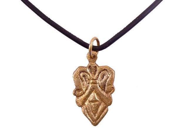 SCANDINAVIAN LADIES PENDANT NECKLACE 12-13 C.AD: Gilt bronze, made by the open face mold process, over 1" height of heart shape. Comprised of addorsed scrolling foliate segments over diamond and chevron base. An evolutionary version of the tradition