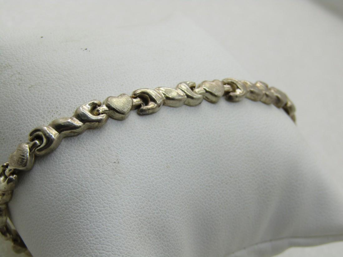 Vintage Sterling Heart Link Tennis Bracelet, 8", Signed: Vintage Sterling Heart Link Tennis Bracelet, 8", 5mm wide, Signed with an A inside a triangule and IL on the right side. Marked sterling and tests as stering. Brushed hearts with a decorative link bet