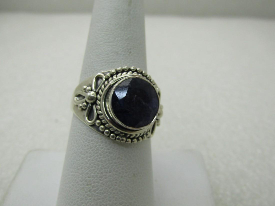 Sterling Silver Amethyst Quartz Ring,, Cigar Bandish: Sterling Silver Amethyst Quartz Ring,, Cigar Bandish Design. Size 9, appx. 6.35 gr. Bowl and rope accent bows. Appx. 10.5mm round bezel-set amethyst quartz stone that sits up off the top of the ring. 