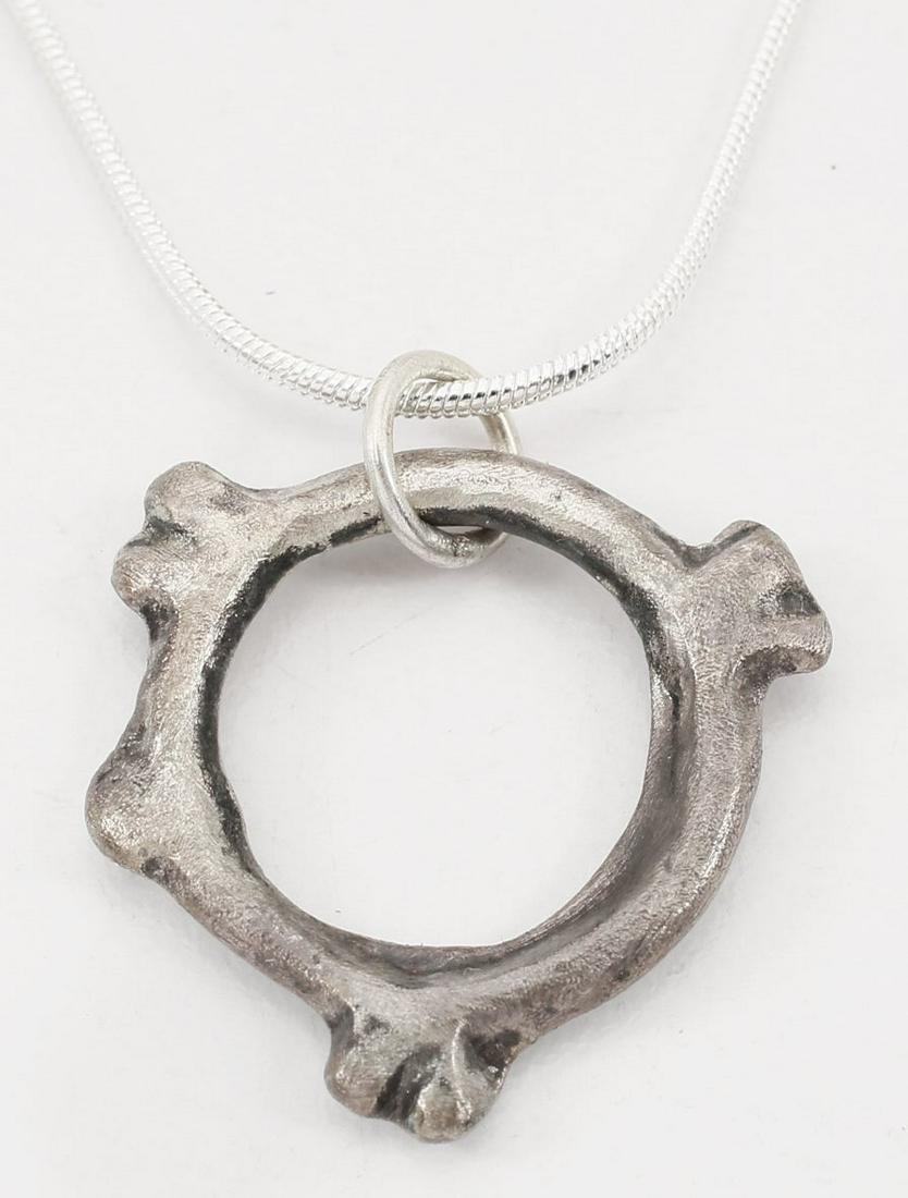 RARE VARIANT CELTIC PROSPERITY RING NECKLACE: 5th-2nd Century BC. Just about 1” width. Complex form, a ridged ring with double spheres at the third points and a single sphere between two pairs. This and other variations are known and rarely