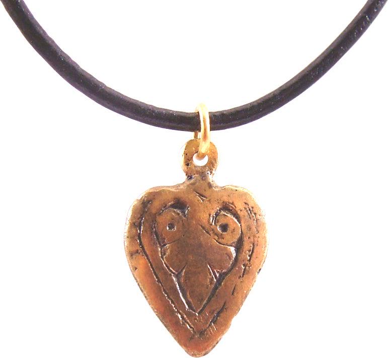 EXTRAORDINARY VIKING HEART NECKLACE C.850-1050 AD: Fine example in its fully evolved form. Over 3/4” height plus the suspension loop. Fully evolved heart form with the sides scrolling at the top and forming the cusp. The field with a trefoil. Ma