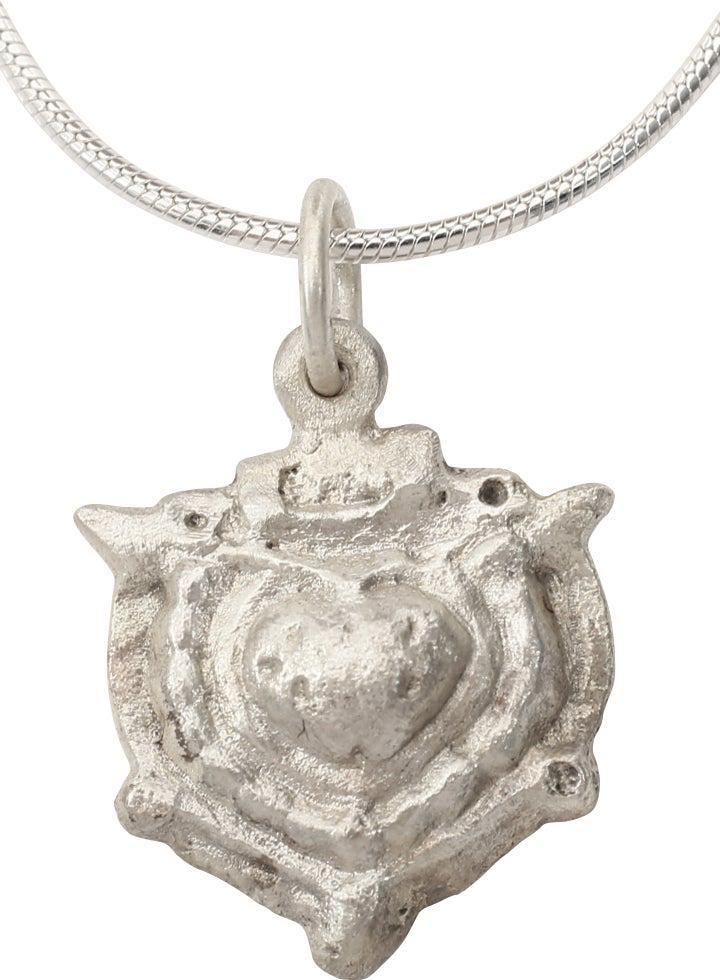 FINE VIKING HEART NECKLACE C.900-1050 AD: Over 5/8” height plus the suspension loop, with nubs at the sixth points. Framed central bordered raised heart of full round evolved form with cusped top. A heart within a heart. Made by the ope