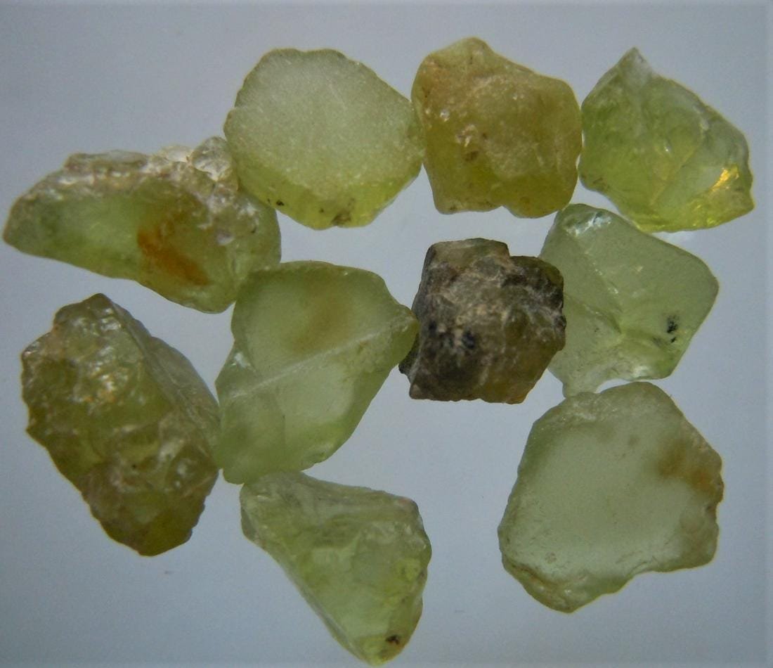 10.4 CT SET OF 10 PERIDOT - UNTREATED GEMSTONES: Title: 10.4 CT SET OF 10 PERIDOT - UNTREATED GEMSTONES Origin: Suppat, Kaghan Valley, Kohistan, Pakistan Size: 0.4-0.7 cm / 2.08 gram Additional Information: set of 10 green peridot Reserve: $5.00 Shi