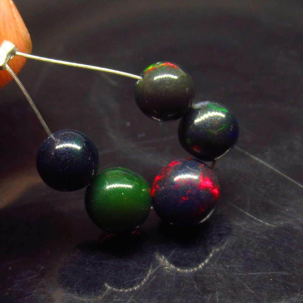 4.66 Ctw Natural 5 Drilled Black Opal Ball Beads: No Reserve! Title: 4.66 Ctw Natural 5 Drilled Black Opal Ball Beads Stone Clarity: Translucent Gemstones: Black Opal Beads Size/Dimensions: 4.66 Carat Weights: 5.70 to 6.20 mm / 5 PC's Additional Info