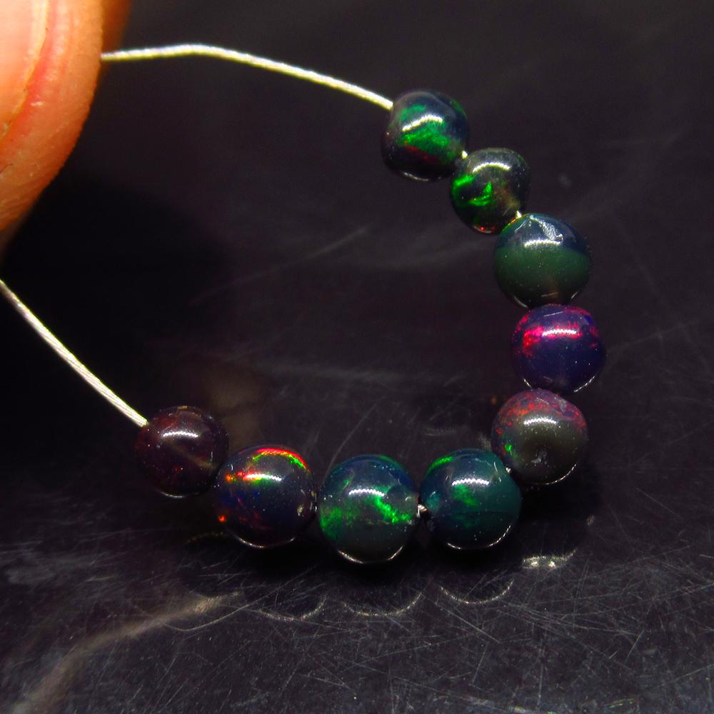 2.18 Ct Natural 9 Drilled Black Fire Opal Ball Beads: No Reserve! Title: 2.18 Ct Natural 9 Drilled Black Fire Opal Ball Beads Stone Clarity: Translucent Gemstones: Natural Black Opal Beads Carat Weights: 2.18 Size/Dimensions: 4.00 to 4.20 mm / 9 PC's Add