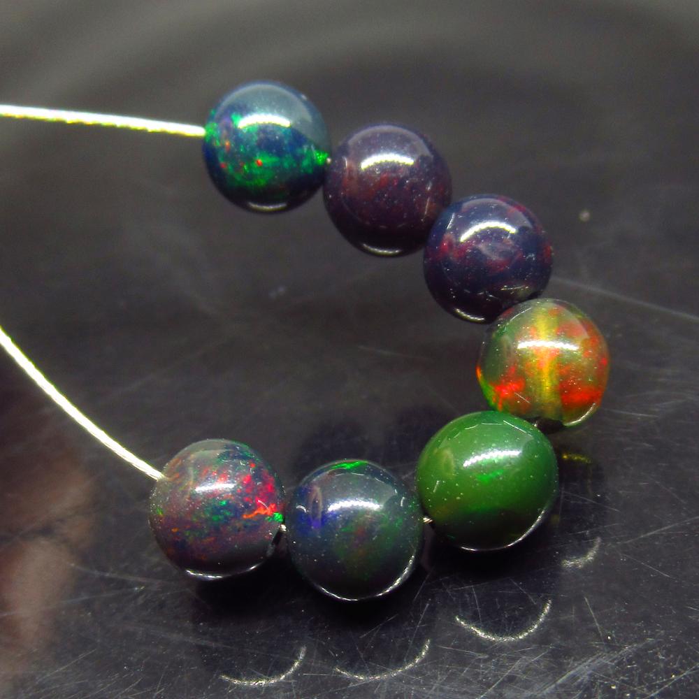 4.24 Ct Natural 7 Drilled Black Fire Opal Ball Beads: No Reserve! Title: 4.24 Ct Natural 7 Drilled Black Fire Opal Ball Beads Stone Clarity: Translucent Gemstones: Natural Black Opal Beads Carat Weights: 4.24 Size/Dimensions: 5.00 to 5.30 mm / 7 PC's Add