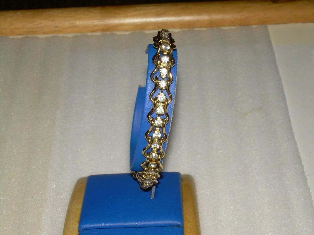 Chain Link CZ Tennis Bracelet - Gold Tone - 8": Vintage clear CZ tennis bracelet. Stones are sparkly and clear no gray. Each stone is prong set. There are no markings on the bracelet. Bracelet has a flip over locking clamp. Bracelet is 8" long. Add