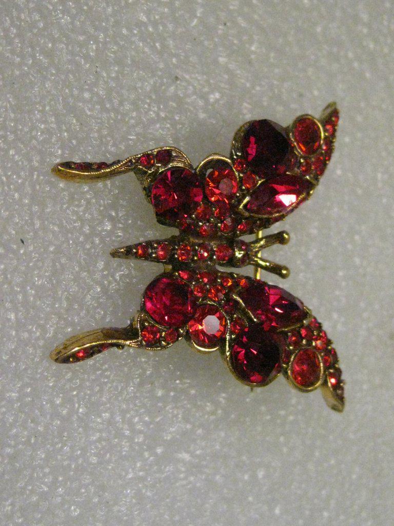 Vintage Gold Tone Red Rhinestone Butterfly Brooch: Vintage Jewelry: Vintage Gold Tone Butterfly Brooch, Red rhinestones, signed Pell. Mid-Century. Rhinestones are in different shades and shapes. It is appx. 1.75" wide and wide from wing to wing. The t