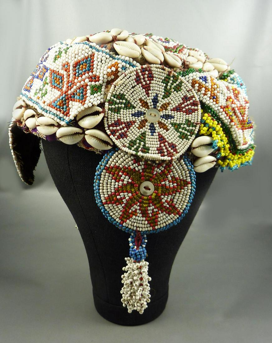 Vintage Afghan headdress probably Kuchi from Central: Details Vintage from the 1960s Materials: Glass Description A vintage beaded headdress or hat, most probably from the Kuchi people living mainly in Afghanistan. Made of tiny colorful glass beads sewn 