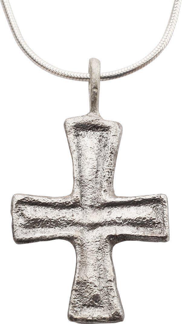 MEDIEVAL PEASANT’S CHRISTIAN CROSS NECKLACE: The period of the spread of Christianity throughout Europe. Silvered bronze, just under 1” height plus the suspension loop. The cross beam centered and each beam flared toward the ends as with t