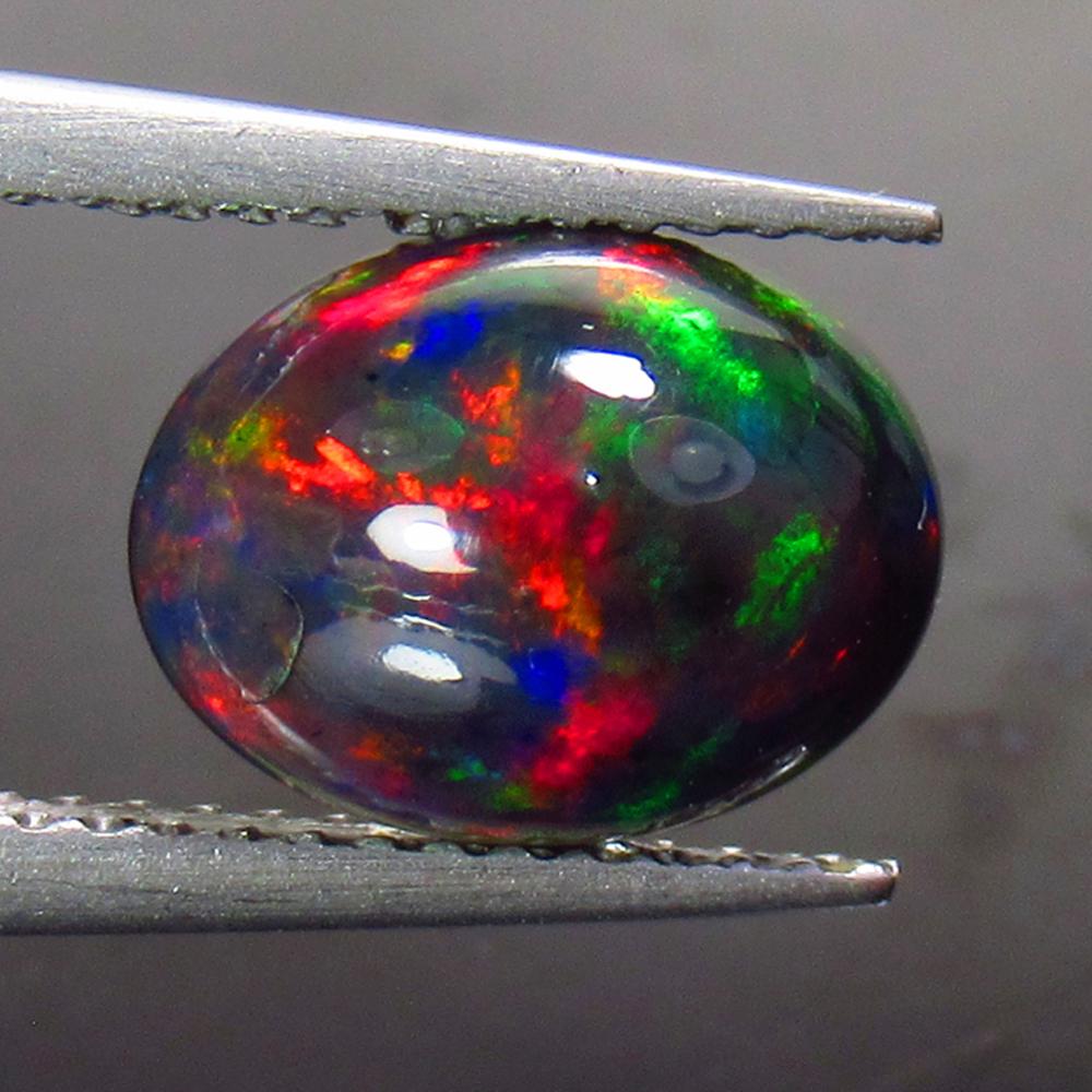 1.86 Ctw Natural Ethiopian Black Fire Opal Oval Cab: No Reserve! Title: 1.86 Ctw Natural Ethiopian Black Fire Opal Oval Cab Stone Clarity: Opaque Gemstone:Black Opal Carat Weight: 1.86 Size/Dimensions: 10.50 x 8.00 x 5.10 mm Additional Information: Exce