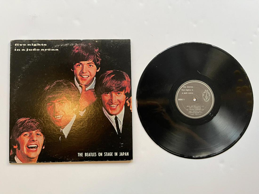 FIVE NIGHTS IN A JUDO ARENA - THE BEATLES ON STAGE IN: FIVE NIGHTS IN A JUDO ARENA - THE BEATLES ON STAGE IN JAPAN. DW426 - Original issues of this unofficial release had full-color covers. Track A2 correctly shown as "She's A Woman" on the label. Track A