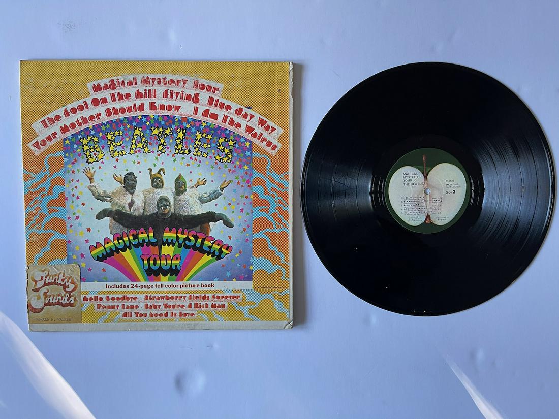 MAGICAL MYSTERY TOUR: MAGICAL MYSTERY TOUR. THE BEATLES. CAPITOL. SMAL 2835. WITH FUNKY SOUNDS STICKER ON FRONT COVER AND ALBUM LABEL. INCLUDES BOOKLET. Notes Label variation: "Mfd. By Apple Records, Inc." at bottom of sid