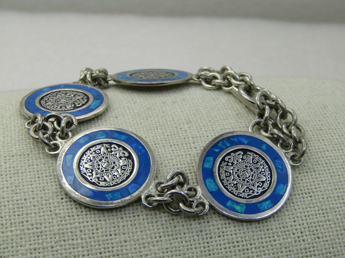 Vintage Sterling Aztec Sun & Opal Bracelet, 7.25",: Vintage Sterling Aztec Sun & Opal Bracelet, 7.25", Toggle Clasp, 22.08 Gr., Four links with created opal inlaid frame and a center of the Aztec/Mayan sun with two strands of Ring links connecting each