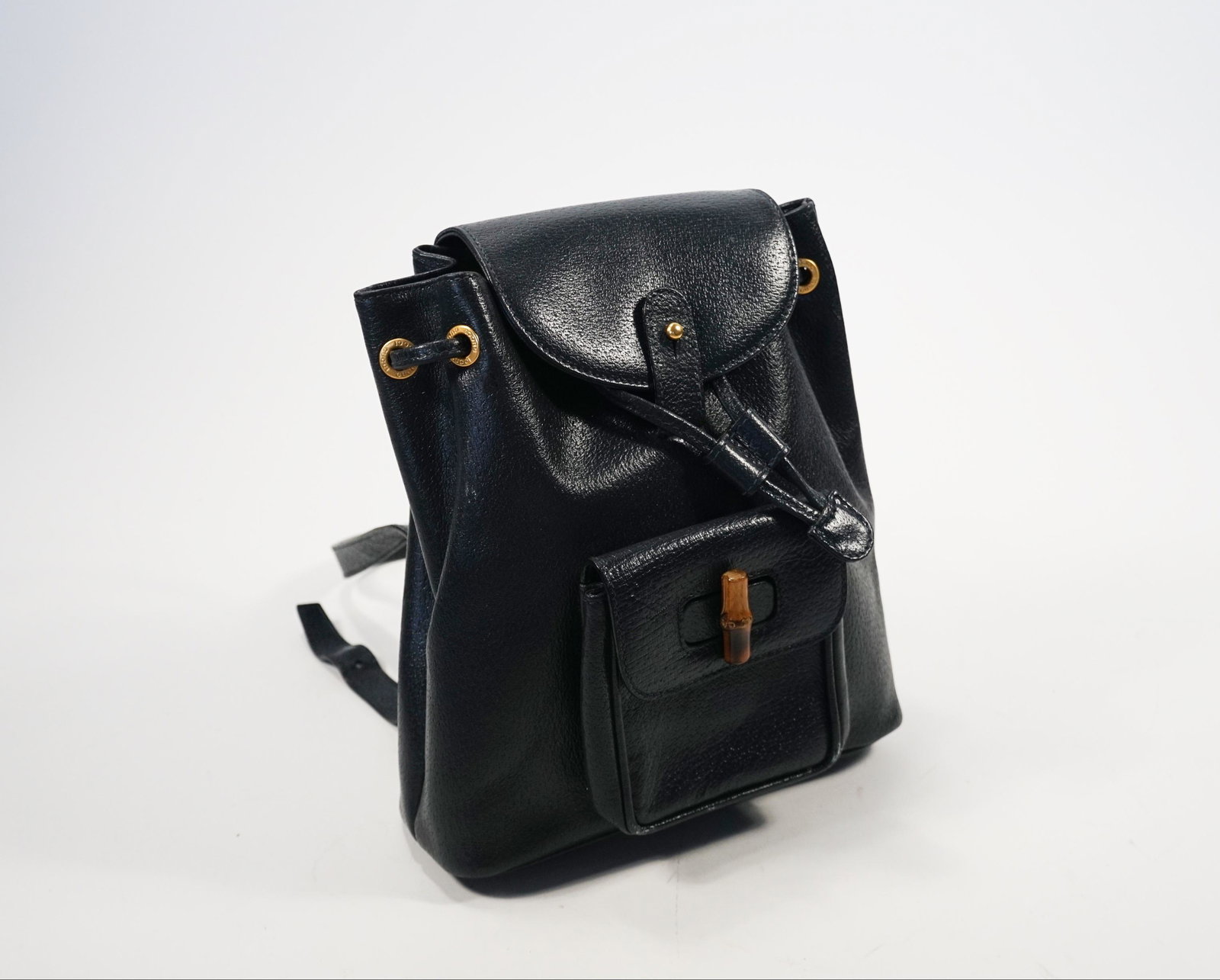 Gucci Mini Navy Bamboo Backpack: Title: Gucci Mini Navy Bamboo Backpack Brand/Designer: Gucci Materials: leather Dimension: L 8.5 W 3 H 9.5 Additional Information: Gucci Mini Navy Bamboo BackpackPreowned items have wear and can be da