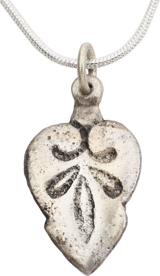 FINE VIKING HEART NECKLACE 10TH-11TH CENT AD: 7/8" height plus the loop. 10th-11th Century AD. Fine full heart, high relief with cusped top. Stepped below center and the field with a trefoil below addorsed cusps. Made by the open face mold proces